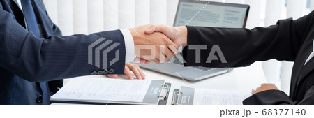 two business people shaking hands of Candidate 68377140