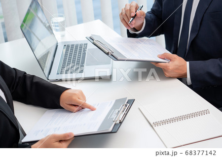 confident businessman sitting in front of office confident businessman sitting in front of office 68377142