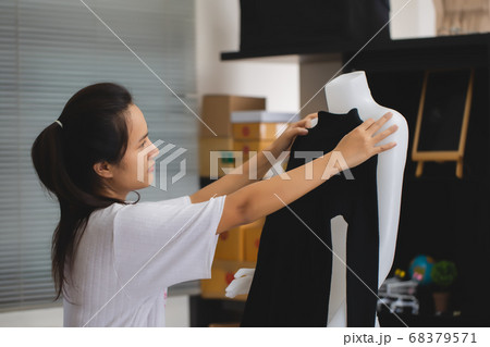 Asian female seller working online e-commerce Asian female seller working online e-commerce 68379571