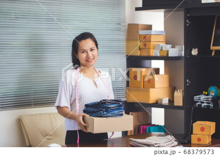 Asian female seller prepare parcel box of product Asian female seller prepare parcel box of product 68379573
