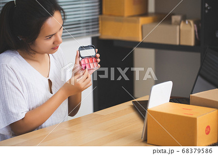 Asian female seller using a tablet selling Asian female seller using a tablet selling 68379586