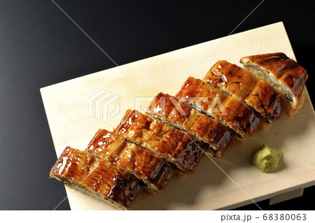 寿司下駄に盛り付けられた鰻の姿寿司とワサビ（黒背景、俯瞰） 68380063
