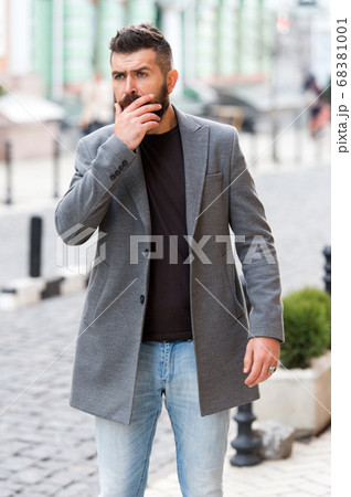 Businessman catching taxi while standing outdoors Businessman catching taxi while standing outdoors 68381001