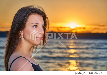 Portrait of a young brunette girl against  68382242