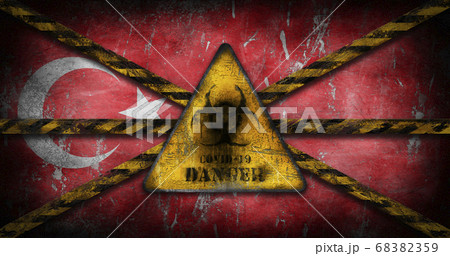 Coronavirus COVID-19 outbreak. Worn Yellow Biohazard, danger, warning sign over flag of Turkey 68382359