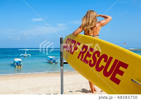 Lifeguard woman stand with surf rescue board on Lifeguard woman stand with surf rescue board on 68383750