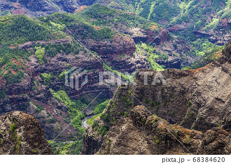 Elevated view of deep canyons, green fertile valleys and steep peaks of an island landscape Elevated view of deep canyons, green fertile valleys and steep peaks of an island landscape 68384620