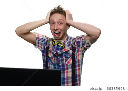 Extremely stressed and desperated teenage boy in front of a computer screen. Extremely stressed and desperated teenage boy in front of a computer screen. 68385998