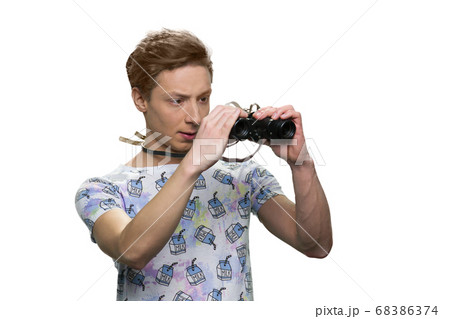 Caucasian teen boy is looking through binoculars. 68386374