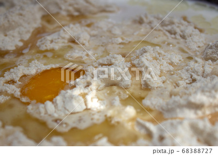 Unmixed ingredients of bread dough: eggs, wheat flour, oil and yeast Unmixed ingredients of bread dough: eggs, wheat flour, oil and yeast 68388727