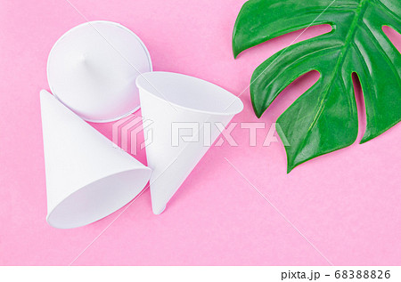 Disposable paper cone water cups with green leaf. Disposable paper cone water cups with green leaf. 68388826