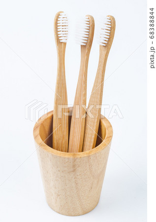 Bamboo toothbrush in wooden glass. Bamboo toothbrush in wooden glass. 68388844