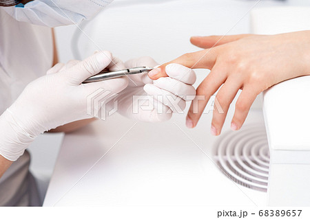 Close up of manicurist using manicure cutter 68389657
