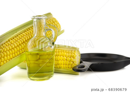 Corn oil in decanter and fresh corncobs 68390679