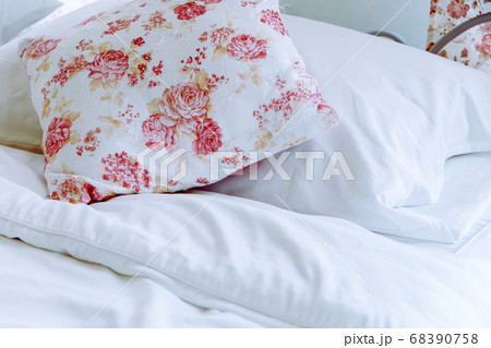 Bright bedroom interior with flower pattern pillows on bed Bright bedroom interior with flower pattern pillows on bed 68390758