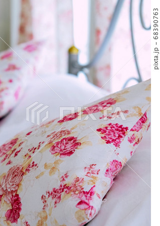 Bright bedroom interior with flower pattern pillows on bed Bright bedroom interior with flower pattern pillows on bed 68390763