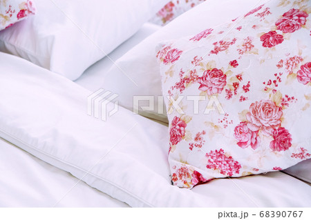 Bright bedroom interior with flower pattern pillows on bed Bright bedroom interior with flower pattern pillows on bed 68390767