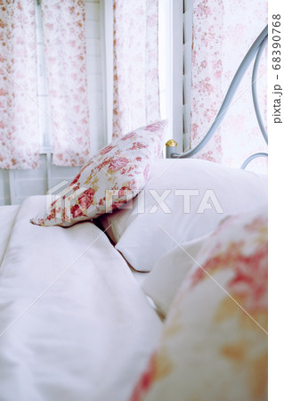 Bright bedroom interior with flower pattern pillows on bed  68390768