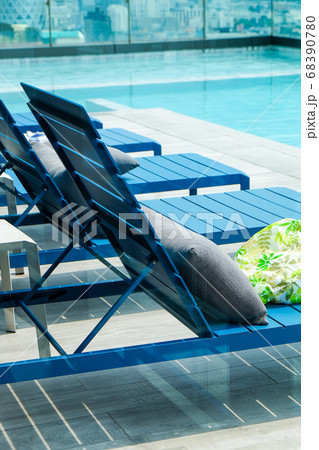 Swimming pool with chaise loungers background 68390780