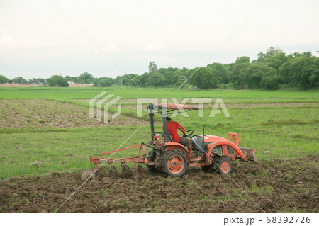 Tractor working plows a field on the farm for Tractor working plows a field on the farm for 68392726