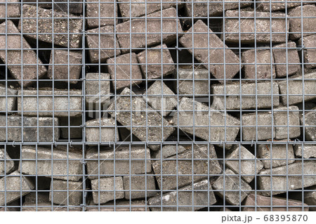 Stone wall of concrete bricks and mesh. Stone wall of concrete bricks and mesh. 68395870