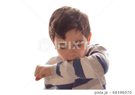 A boy sneezes or coughs into his elbow on white background. A boy sneezes or coughs into his elbow on white background. 68396070