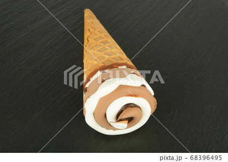 Waffle cone with ice cream on a black background. Waffle cone with ice cream on a black background. 68396495