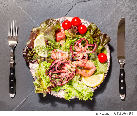 Octopus on blue plate with salad and lemon Octopus on blue plate with salad and lemon 68396794