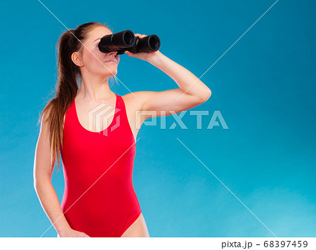 lifeguard on duty looking through binocular 68397459