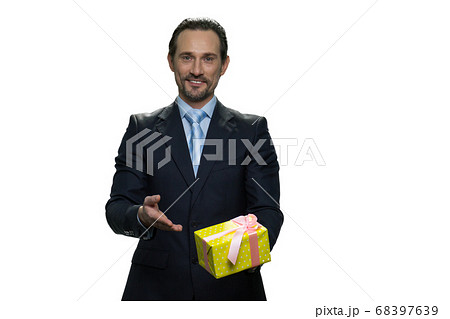 Cheerful boss holding a present in yellow box. 68397639