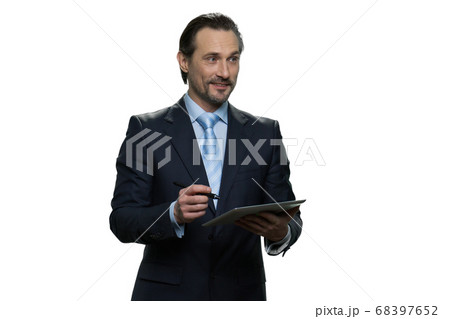 Smiling businessman is writing on the tablet. 68397652
