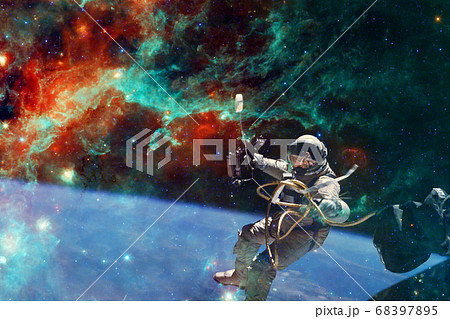 Astronaut. Nebula, cluster of stars. Elements of this image furnished by NASA Astronaut. Nebula, cluster of stars. Elements of this image furnished by NASA 68397895