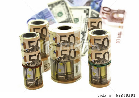 currency of different denominations in rolls and in bulk on a white background currency of different denominations in rolls and in bulk on a white background 68399391