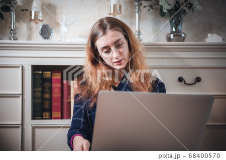 Young Woman Working on Computer Laptop at Home Young Woman Working on Computer Laptop at Home 68400570