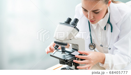 Scientist researcher uses microscope in laboratory Scientist researcher uses microscope in laboratory 68405777