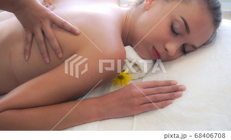 Woman gets back massage spa by massage therapist. 68406708