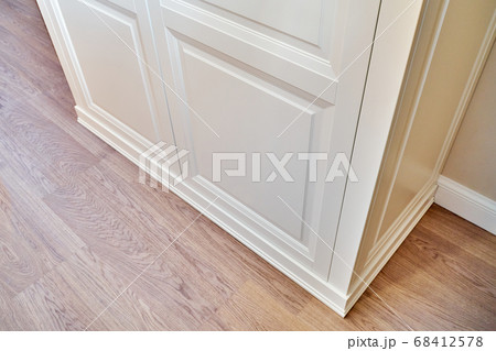 Classic wardrobe. Fragment of the bottom of the cabinet. Classic furniture close-up 68412578