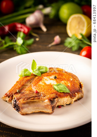 Fried pork entrecote on the bone 68413997