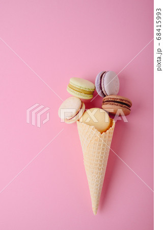 Several colorful macaroon cakes on a colored 68415993