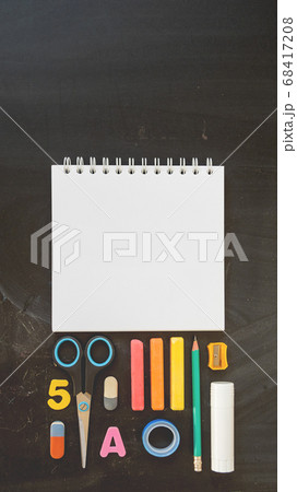 Top view on colorful stationery. Back to school flat lay concept. Vertical blackboard background with copy space. 9-16 ratio for mobile applications. 68417208