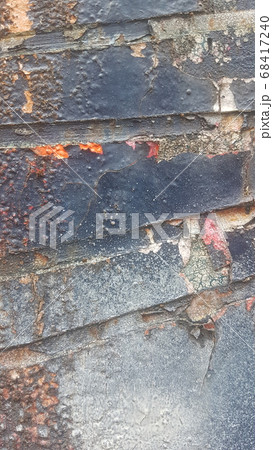Old weathered colorful paint that separates from rusty metal and peels off 68417240