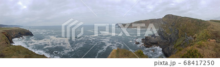 View into a bay in the Biskaya in northern Spain with rocks and big waves View into a bay in the Biskaya in northern Spain with rocks and big waves 68417250
