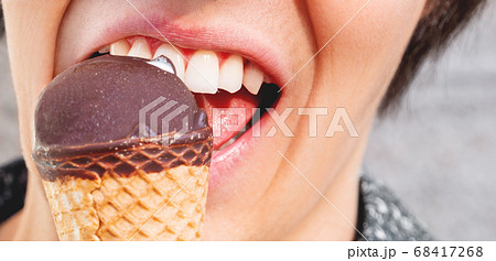 Man in blue shirt is eating ice-cream. Closeup photo of cold dessert. Summer fun. Man in blue shirt is eating ice-cream. Closeup photo of cold dessert. Summer fun. 68417268
