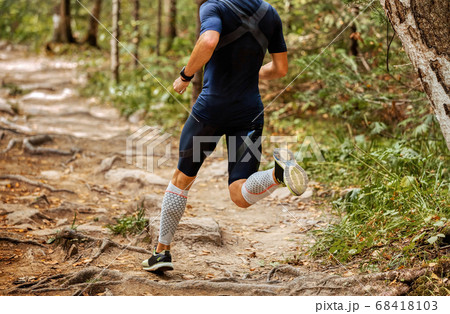 man athlete runner run forest trail 68418103