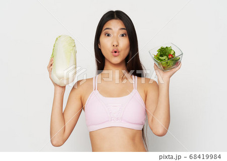 Eating beautiful woman slim figure salad in a plate and vegetables 68419984