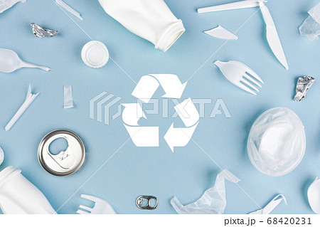 Top view of Different garbage materials with recycling symbol on blue background 68420231