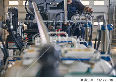 Competent mechanic working in the hangar with technic Competent mechanic working in the hangar with technic 68422140