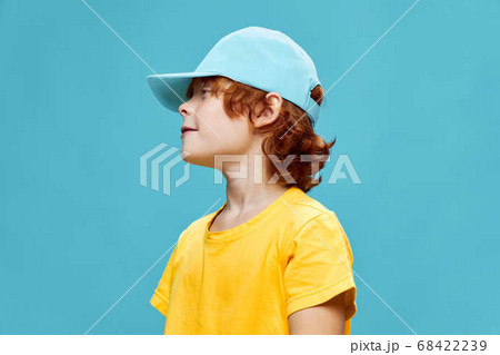A child in a blue cap looks towards the red-haired A child in a blue cap looks towards the red-haired 68422239