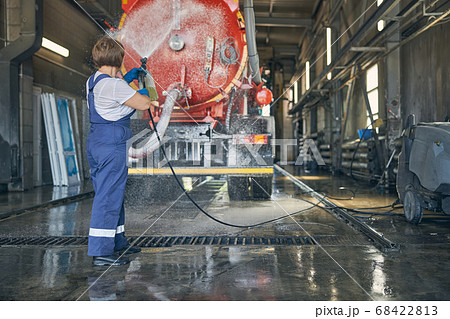 Concentrated female person washing big special auto 68422813