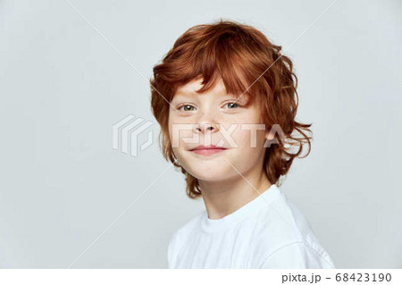 red-haired boy white t-shirt gray background studio close-up red-haired boy white t-shirt gray background studio close-up 68423190